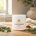 GutNaturals L-Glutamine powder tub on a sunlit oak kitchen counter with sage, rosemary and a glass of water