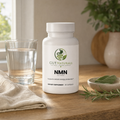 GutNaturals NMN on a sunlit oak kitchen counter with sage, rosemary and a glass of water