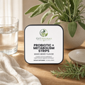 GutNaturals Probiotic + Metabolism Strips tin on a sunlit oak kitchen counter with sage, rosemary and a glass of water