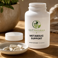 GutNaturals Metabolic Support bottle open with capsules in a ceramic dish on a sunlit oak counter
