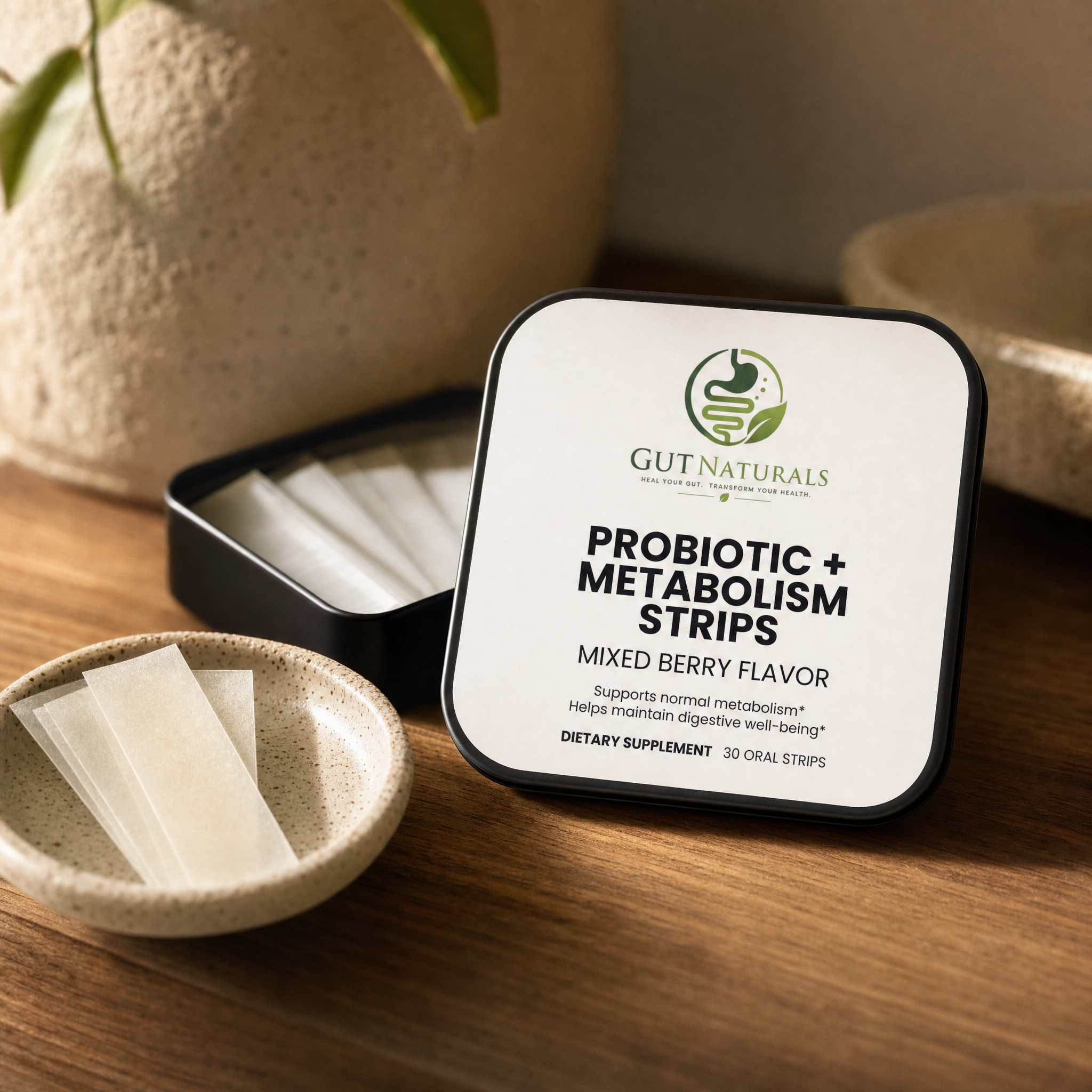 GutNaturals Probiotic + Metabolism Strips tin open with oral strips in a ceramic dish