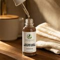 GutNaturals Peptide Hair Growth Serum with the applicator lifted and a droplet catching the light